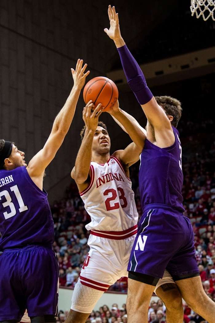Trayce Jackson-Davis (23) shoots between Northwestern's Matthew Nicholson (34) and Robbie Beran (31) during the first half ot the Indiana versus Northwestern men's basketball game.